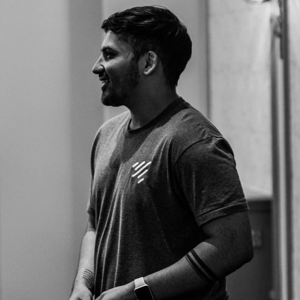 Zee McSparron, smiling, in a grey t-shirt